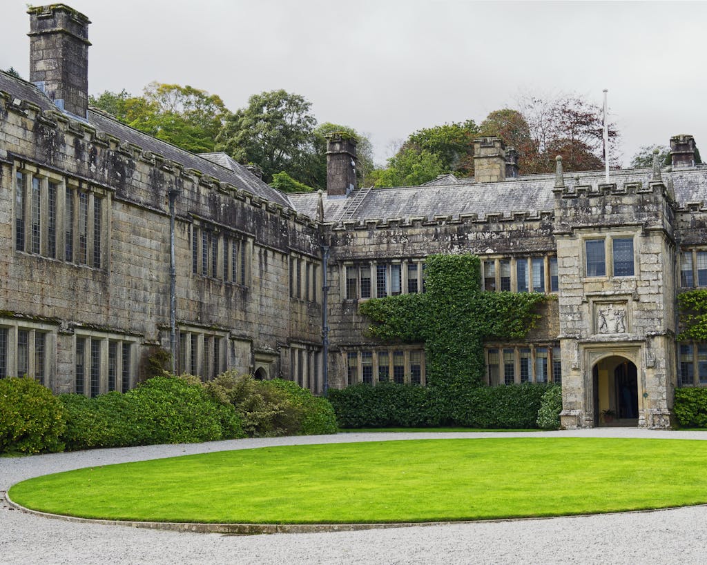 Exterior view of Lanhydrock House, a historic landmark in Cornwall, UK, showcasing its classic architecture.